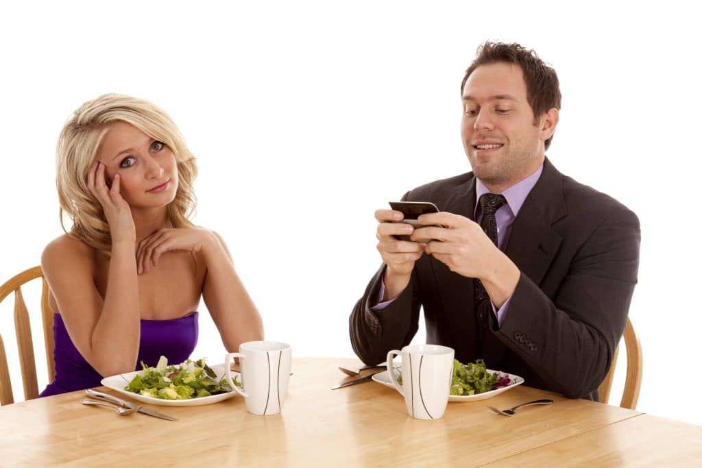 A Man Texting During His Date