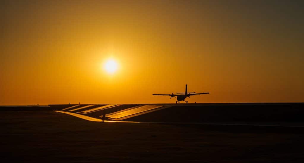 Small Airplane Takes Off On Sunset.