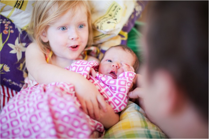 girl holding baby