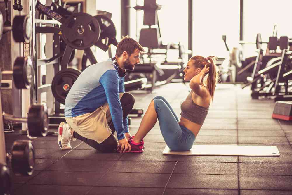 couple supporting each other on a gym