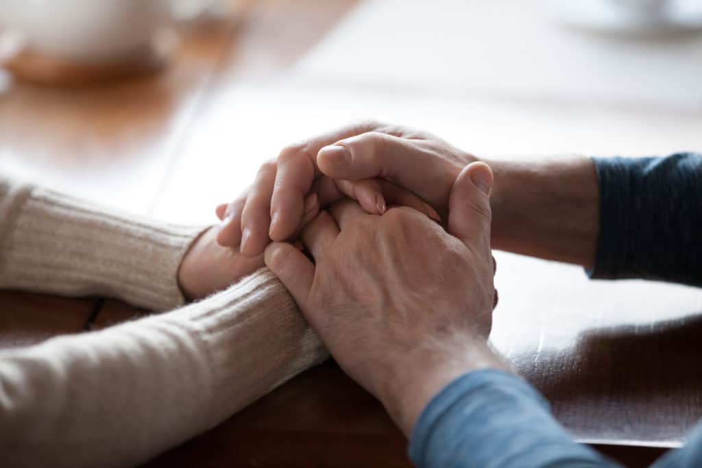 male hands holding female, caring, loving, understanding and supporting